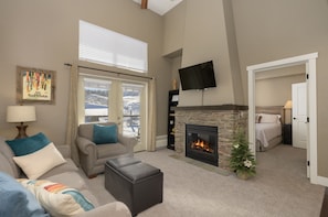 Living area with smart TV, fireplace, and games