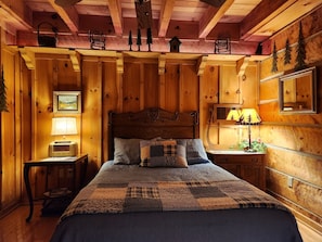 Primary bedroom with queen size bed and walk-in closet