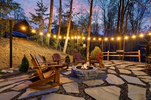 Enjoy a great outdoor space with soft lighting and a real-wood fire pit.