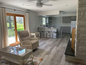 The family room opens to the kitchen with walk-out patio and golf course views.
