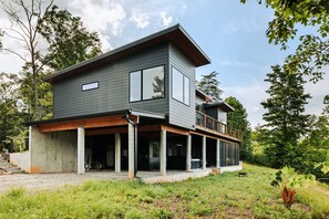 Tucked into the trees with room to roam, this modern mountain retreat features covered parking for 2 cars. Sleek lines, double decks, and views for days.