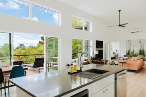 Whether you’re sipping morning coffee at the island or enjoying a game night in the living room, the open-concept design keeps everyone connected and comfortable.