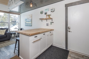 Natural lighting from outside spills into the kitchen nicely, this island is perfect for prepping your meals!