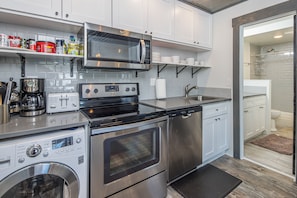 This kitchen offers stainless steel appliances, perfect for a home cooked meal!