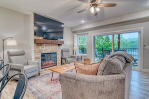 The living room has a sofa sleeper and a blackout shade for the sliding door