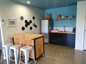 Kitchen area, bench top oven with burners included.