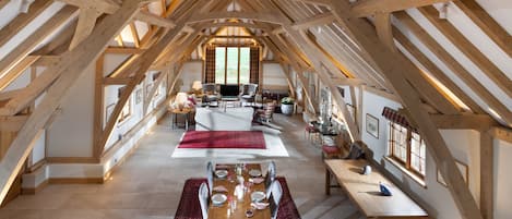 The open-plan sitting and dining room boasts an exposed oak vaulted ceiling