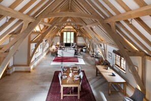 The open-plan sitting and dining room boasts an exposed oak vaulted ceiling
