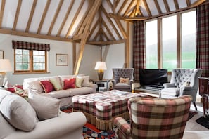 The sitting area enjoys countryside views from the large feature window
