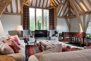 The sitting area with comfy seating and exposed oak beams