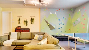 Take on the Climbing wall, ping pong, foosball.  Or cuddle up on the Article sectional for Ninetendo Switch, board games, or maybe just an action movie on the 70" screen. 