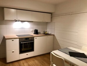 The cube apartment features a small but fully equipped kitchen, perfect for cooking a meal after a long day.