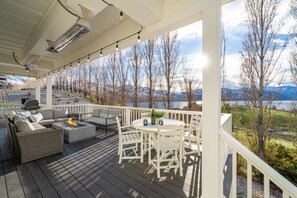 Main level deck with table & firepit and uplake view