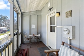 Catch bay breezes on the back Screened Porch and relax in the shade.