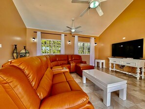 Living room: large sofa with large TV for entertaining your relaxing time