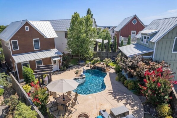 Beautiful backyard! Main house and pool house on each side of the private pool.