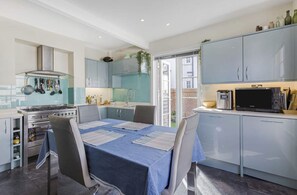 Kitchen and access to sunny courtyard garden