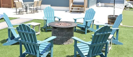 Make memories around the gas firepit with Adirondack-chair seating for 6.