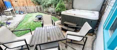 Backyard with private hot tub, fire ring and grill