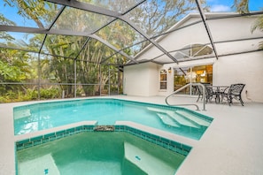 Private swimming pool with a hot tub