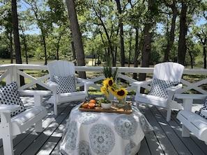 Enjoy coffee on the patio surrounded by post oaks.