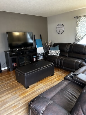 Living room has large L shaped sectional with 3 recliners. Electric fireplace! 