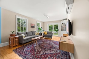 Two living room areas to hang out at. Plenty of seating with new furniture, a piano for sing-a-longs, a pellet stove and a large smart TV with apps.. Board games and books for rainy days.