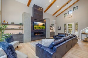 Vaulted Living Room With Floor-To-Ceiling Gas Fireplace And Sectional Sofa