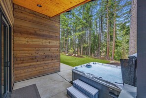 Outdoor Lounge With Covered Hot Tub And Entertaining Deck Space