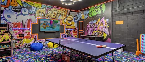 Garage-turned-games-room featuring table tennis, arcade games, air hockey and more!