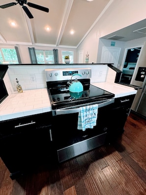 Glass top stove with air fryers part of the oven.