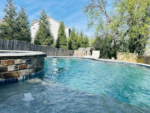 The salt water pool gets plenty of overhead sun and has a waterfall from the hot tub! And one of our favorite things about this backyard is the BIRDS. The birds tend to chirp throughout the day, making this a nature oasis, too.