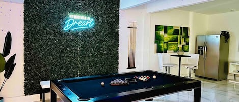 It was all a dream! in this amazing bottom level game and entertainment room. Billiards table sits under the starry overhead lights.