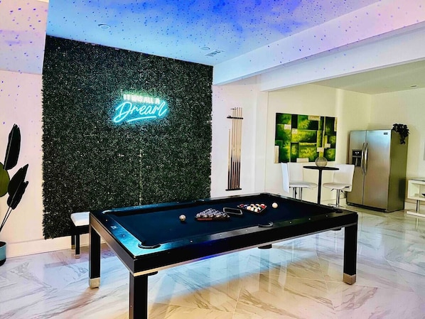 It was all a dream! in this amazing bottom level game and entertainment room. Billiards table sits under the starry overhead lights.