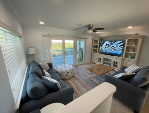 Large screen TV, sofa bed, comfortable living room with large balcony.