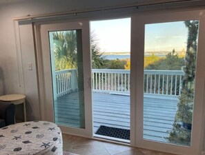 Large balcony with table for 6 and 2 lounge chairs for sunning.