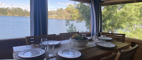 dining room in screen porch overlooking lake
