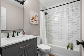 Primary Suite bath with tub/shower combo. 