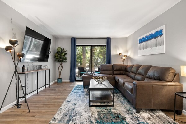 Spacious living area with sliding doors to patio and fenced yard