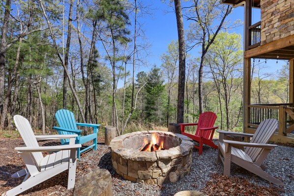 Wood firepit, Adirondack chairs and log tables