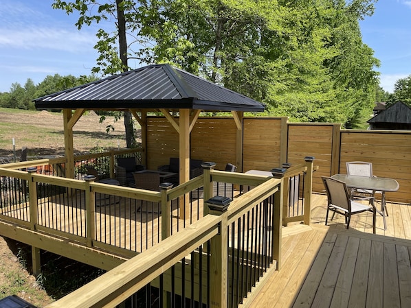 Relax around the fireplace on this brand new deck in the backyard! 