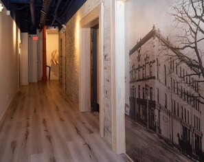 common hallway to enter The Flats showcase an original picture of the building from 1890