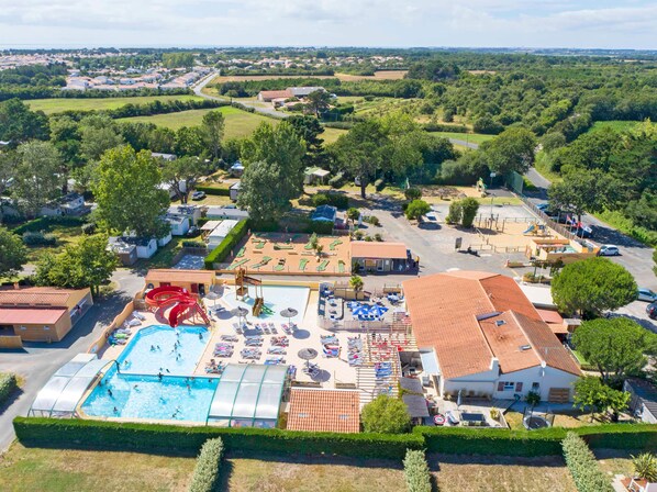 Expansive view of the resort with pools and outdoor facilities, offering a range of activities for all ages.
