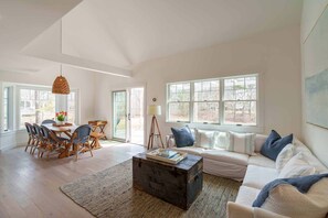 Great Room has Vaulted Ceilings, Living and Dining Areas with Sliding Glass Doors Leading Out to the Deck