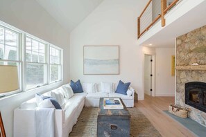 Living Area has Sectional Seating and Word Burning Fireplace