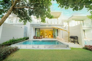 A view of Villa's exterior from the backyard, with a vista of BRG golf course. 