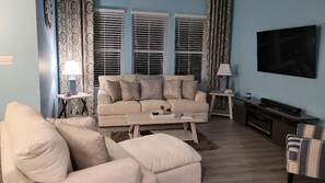 Living Room - 65"TV. Credenza has a built-in fireplace, and sound bar.