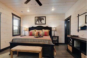 Upstairs Master Bedroom: King Size Bed with an attached Ensuite showcasing a  walk-in tile shower. Fireplace with a walk-out private balcony. 