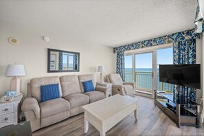 The ocean front living room is well-appointed with comfortable furnishings.