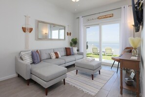 Family room with updated furnishings and views of the bay.